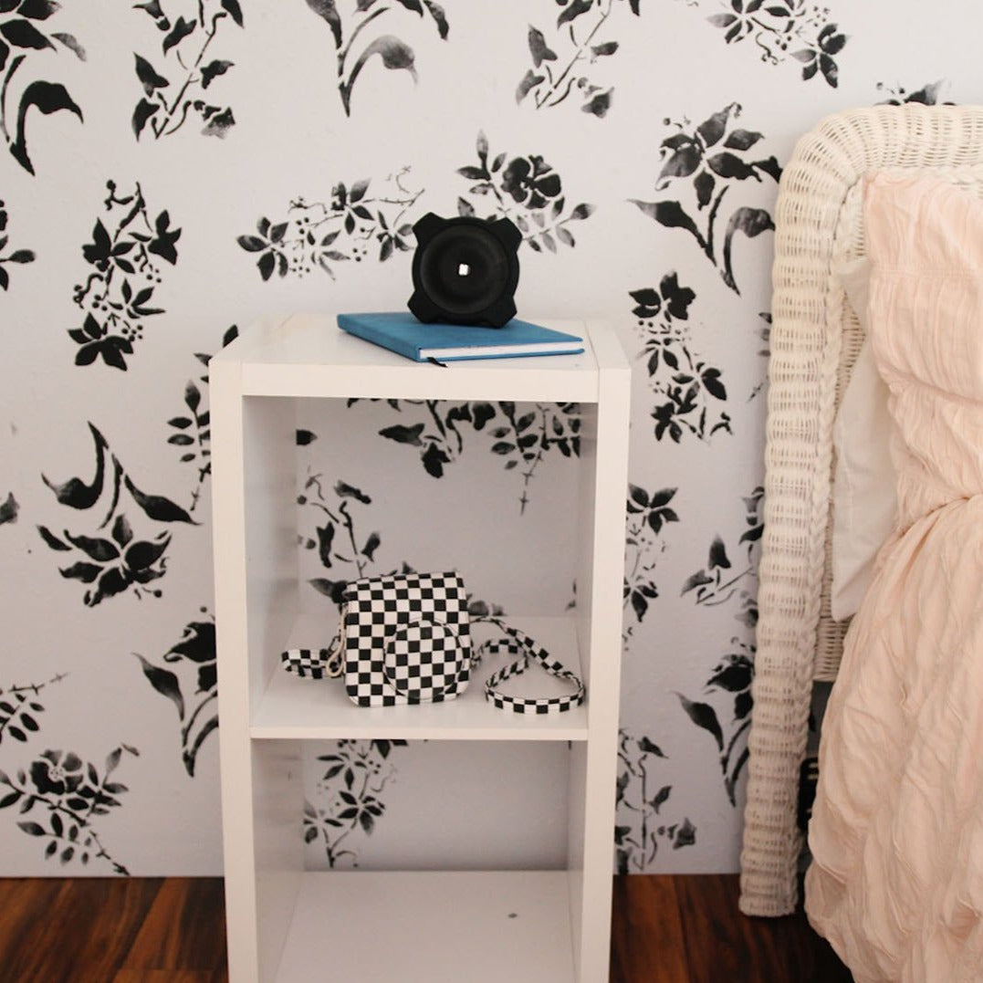 white wall painted with Daffodils, Daisies, Lilies, and Primrose using paint stencil