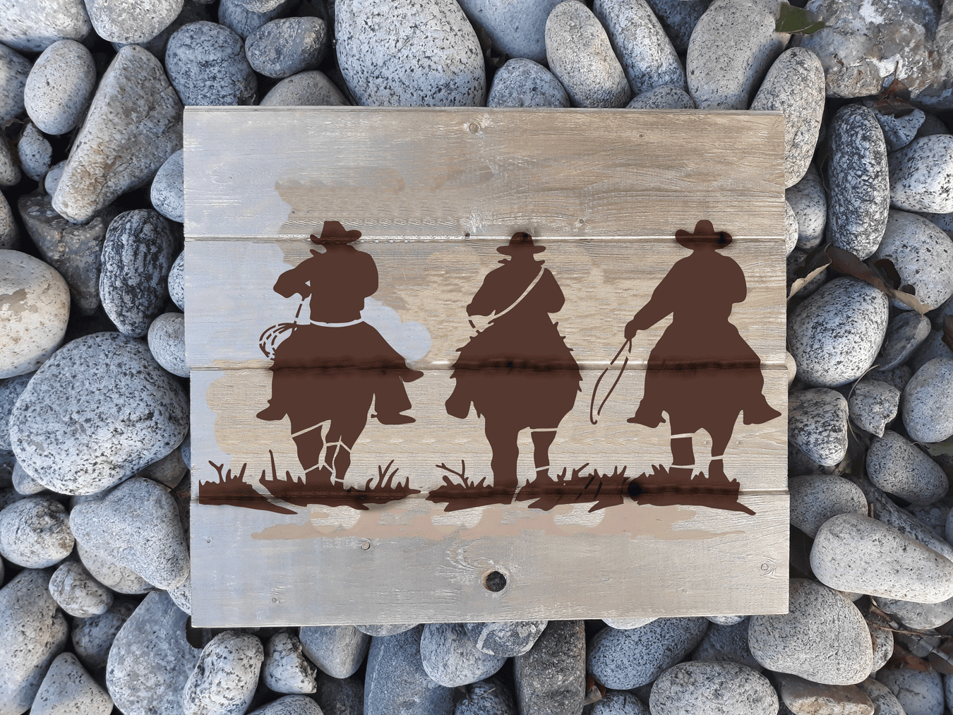 three cowboys riding horses