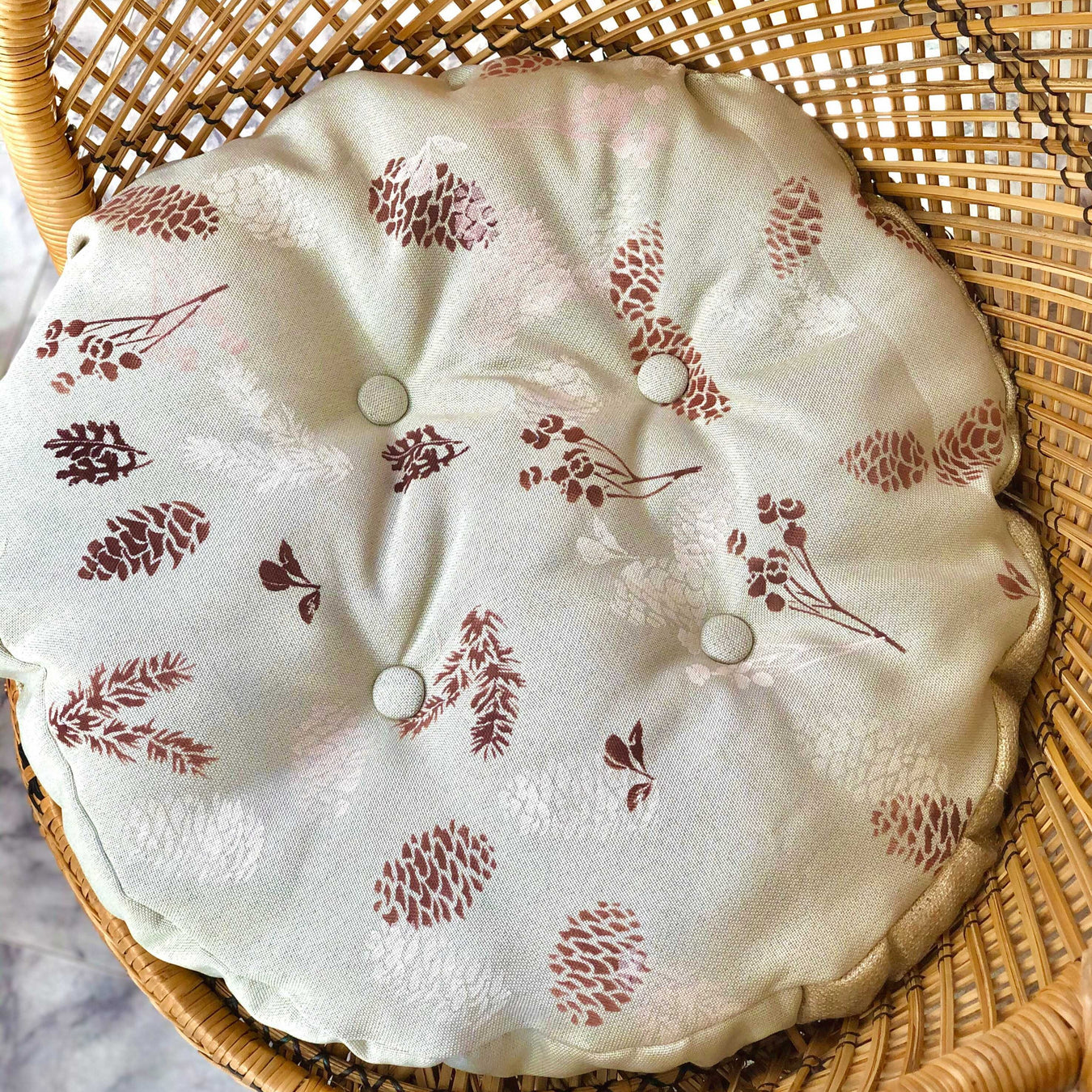 pine cones painted on a pillow using paint stencil